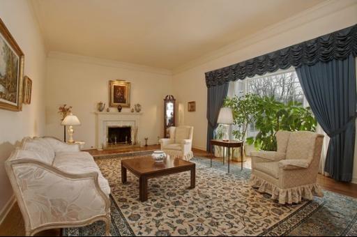 2045 Winnetka Road Northfield, IL 60093 - Photo 3 of 16 a living room with furniture a fireplace and a table