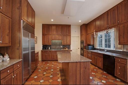 2045 Winnetka Road Northfield, IL 60093 - Photo 5 of 16 a kitchen with stainless steel appliances granite countertop a sink a stove and a refrigerator