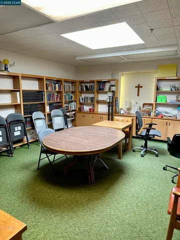 a dining room with furniture and a rug