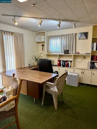 a kitchen with a table chairs and a window