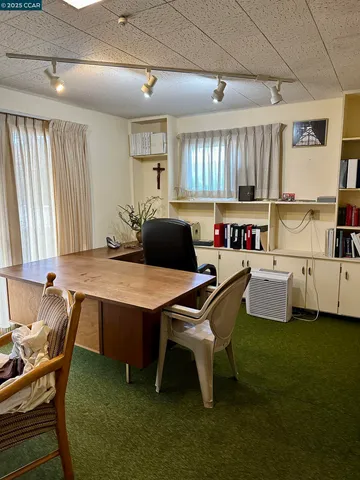 a kitchen with a table chairs and a window