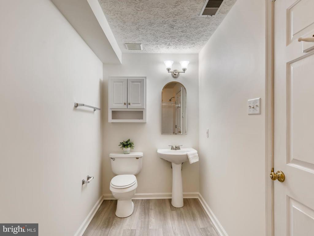 8241 Poplar Mill Road, Unit 8241 Baltimore, MD 21236 - Photo 22 of 26 BATHROOM 2 w/NEW WOOD-STYLE LAMINATE!