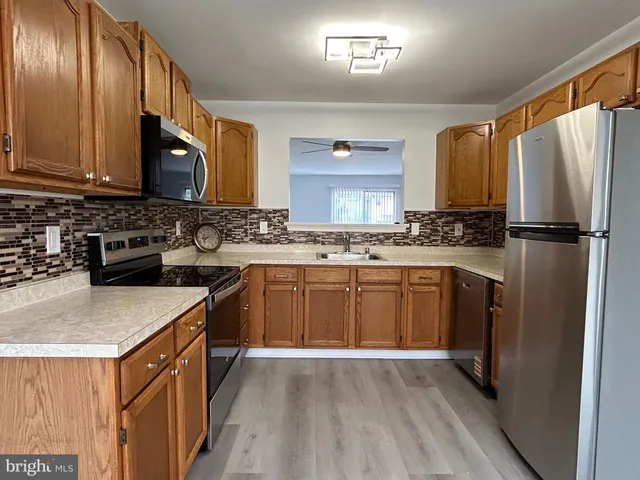 a kitchen with a sink stove and refrigerator