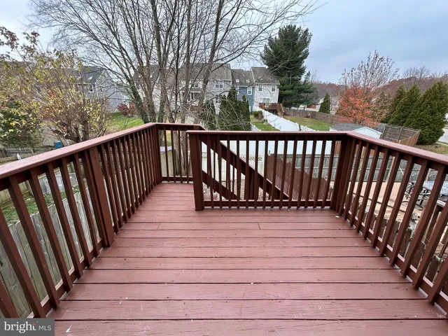 a view of balcony with wooden floor and fence