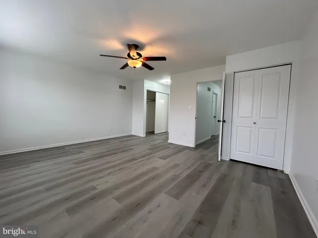a view of a livingroom with a hardwood floor and a ceiling fan