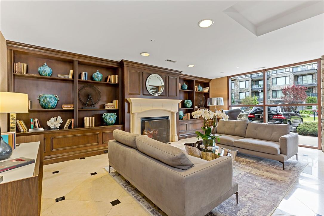 18 Rivers Edge Drive, Unit 507 Tarrytown, NY 10591 - Photo 1 of 1 a living room with furniture a fireplace and lots of white walls