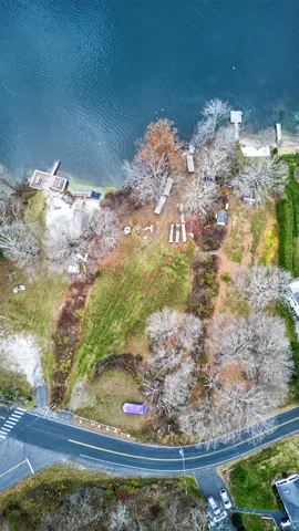an aerial view of a houses with street