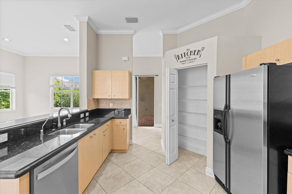 1441 Cardinal Way Weston, FL 33327 - Photo 21 of 96 a large kitchen with a refrigerator a sink and cabinets