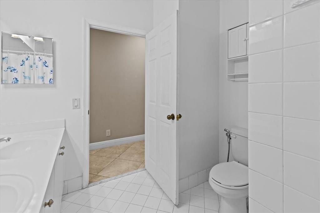1441 Cardinal Way Weston, FL 33327 - Photo 28 of 96 a bathroom with a granite countertop toilet and a shower