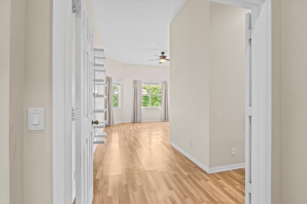 1441 Cardinal Way Weston, FL 33327 - Photo 40 of 96 a view of a hallway with wooden floor and a bathroom