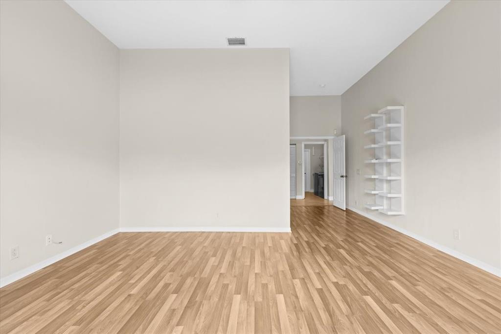 1441 Cardinal Way Weston, FL 33327 - Photo 44 of 96 a view of an empty room with wooden floor and a window