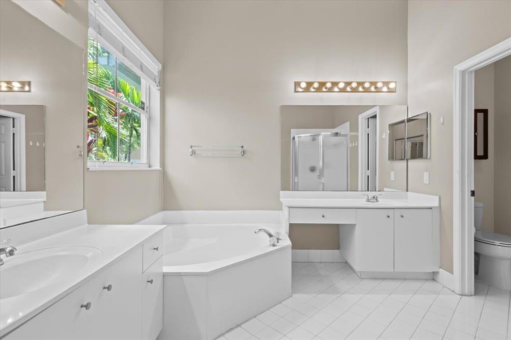 1441 Cardinal Way Weston, FL 33327 - Photo 50 of 96 a spacious bathroom with a tub sink and mirror