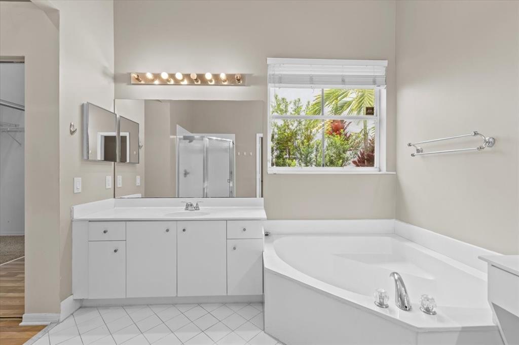 1441 Cardinal Way Weston, FL 33327 - Photo 51 of 96 a bathroom with a bathtub a sink and a window