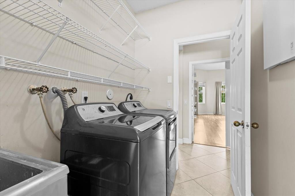 1441 Cardinal Way Weston, FL 33327 - Photo 56 of 96 a utility room with dryer and washer