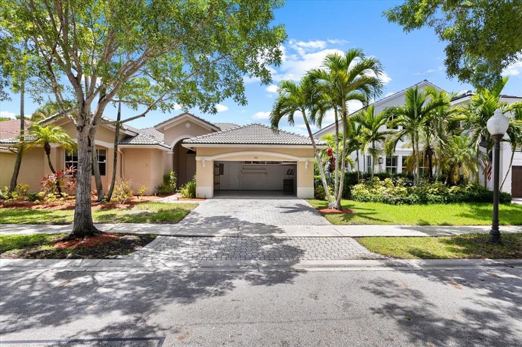 1441 Cardinal Way Weston, FL 33327 - Photo 61 of 96 a front view of a house with garden and yard