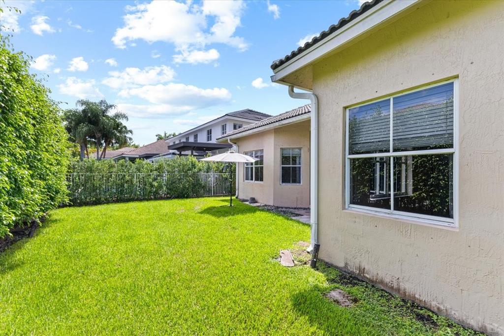 1441 Cardinal Way Weston, FL 33327 - Photo 64 of 96 a view of a backyard with plants and a garden