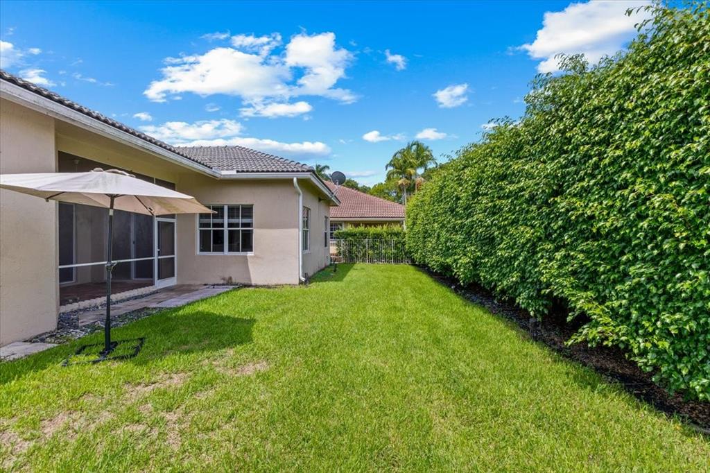 1441 Cardinal Way Weston, FL 33327 - Photo 65 of 96 a view of a backyard with plants and a backyard