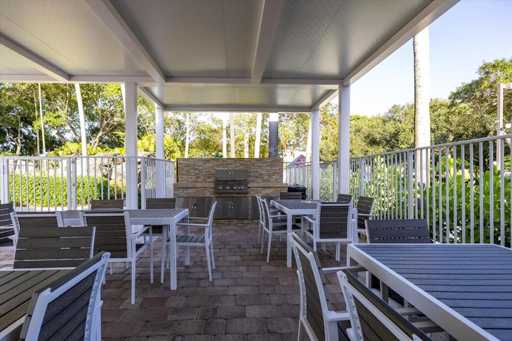 1441 Cardinal Way Weston, FL 33327 - Photo 94 of 96 a view of a patio with a table chairs and a backyard