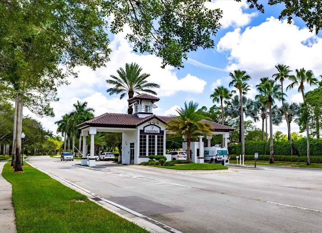 1441 Cardinal Way Weston, FL 33327 - Photo 95 of 96 a view of a street with a table and chairs under an umbrella