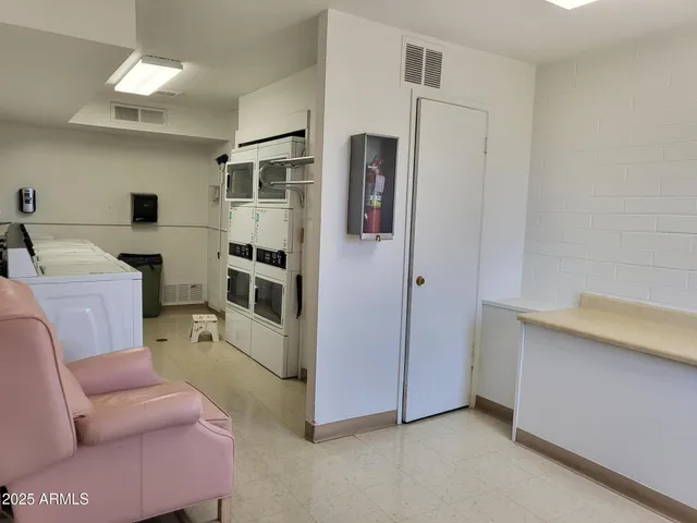 a room with furniture a washer and dryer