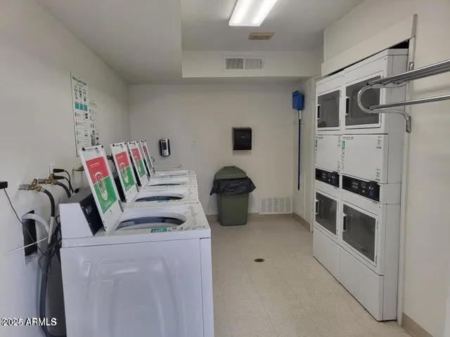 a view of kitchen and washer dryer with a kitchen space