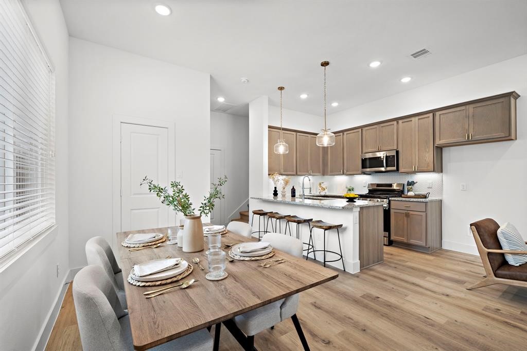 1586 West Tidwell Road Houston, TX 77091 - Photo 13 of 14 a kitchen with a table and chairs in it