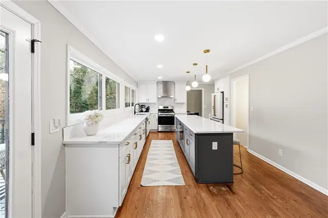 a view of kitchen with sink and wooden floor