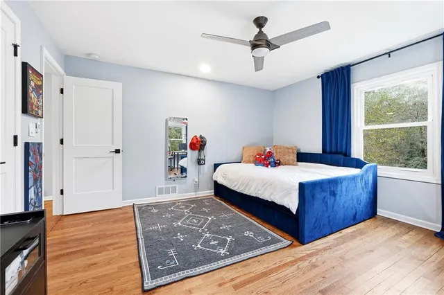 a bedroom with a bed dresser and a window