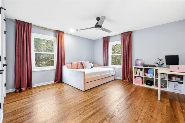 a living room with a bed furniture and a large window
