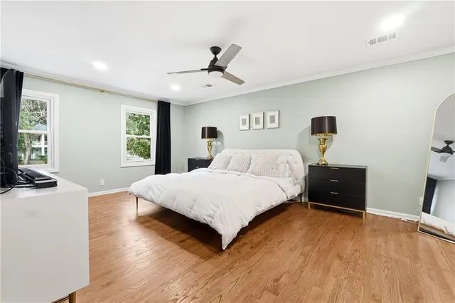 a bedroom with a bed and wooden floor