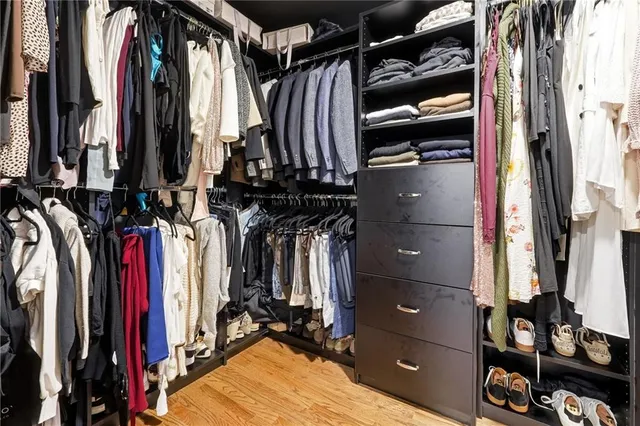 a view of walk in closet with clothes