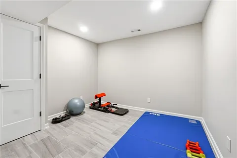 a room with a wooden floor and potted plant