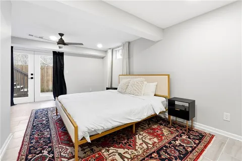 a bed sitting in a bedroom and a chandelier