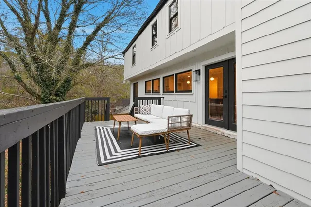 a balcony with furniture and wooden floor