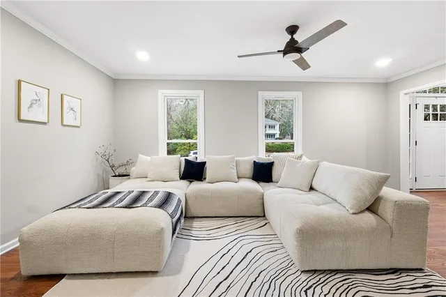 a bedroom with a large bed couch and window