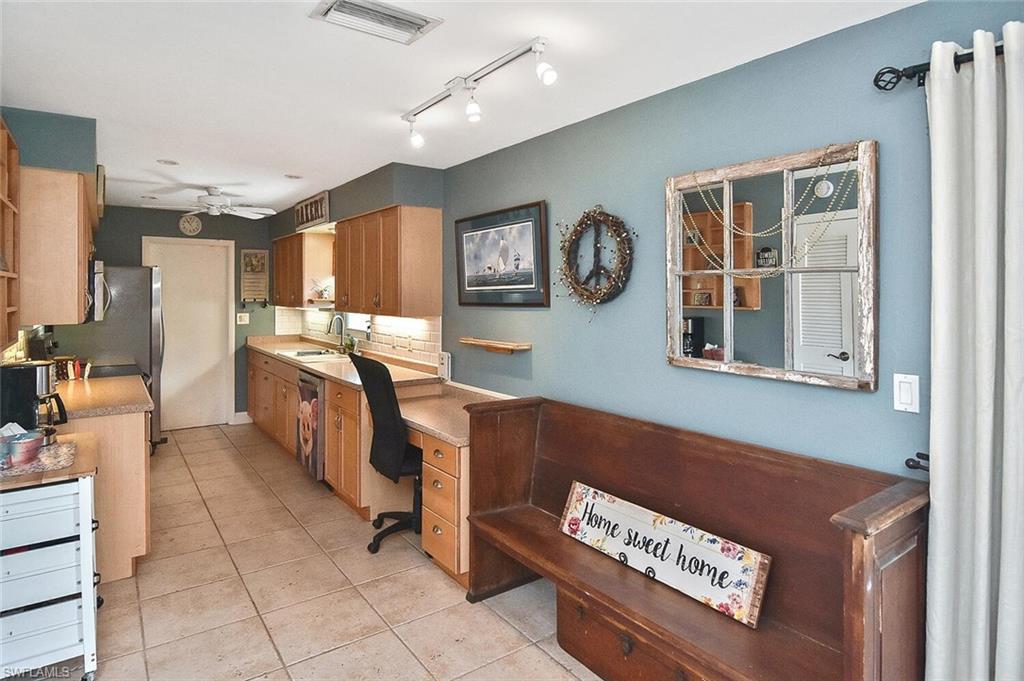 19031 Evergreen Road Fort Myers, FL 33967 - Photo 14 of 44 a room with furniture a flat screen tv and a window