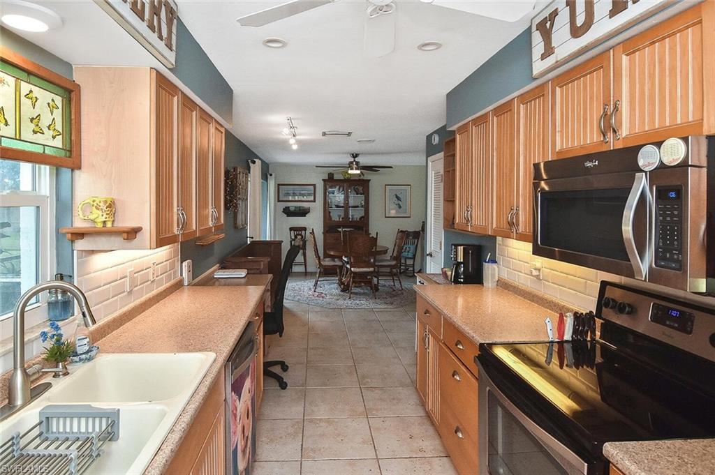 19031 Evergreen Road Fort Myers, FL 33967 - Photo 18 of 44 a kitchen with counter top space appliances and a window