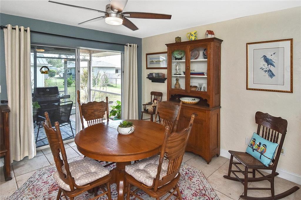 19031 Evergreen Road Fort Myers, FL 33967 - Photo 19 of 44 a dining room with furniture a rug and a large window