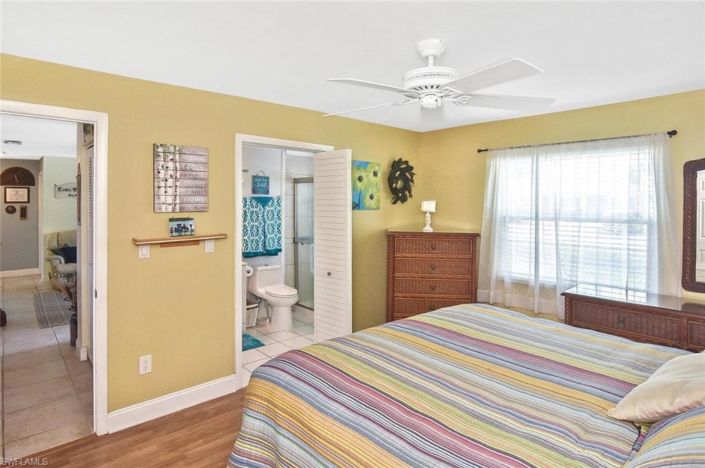 19031 Evergreen Road Fort Myers, FL 33967 - Photo 22 of 44 a bedroom with a bed and a window with mirror
