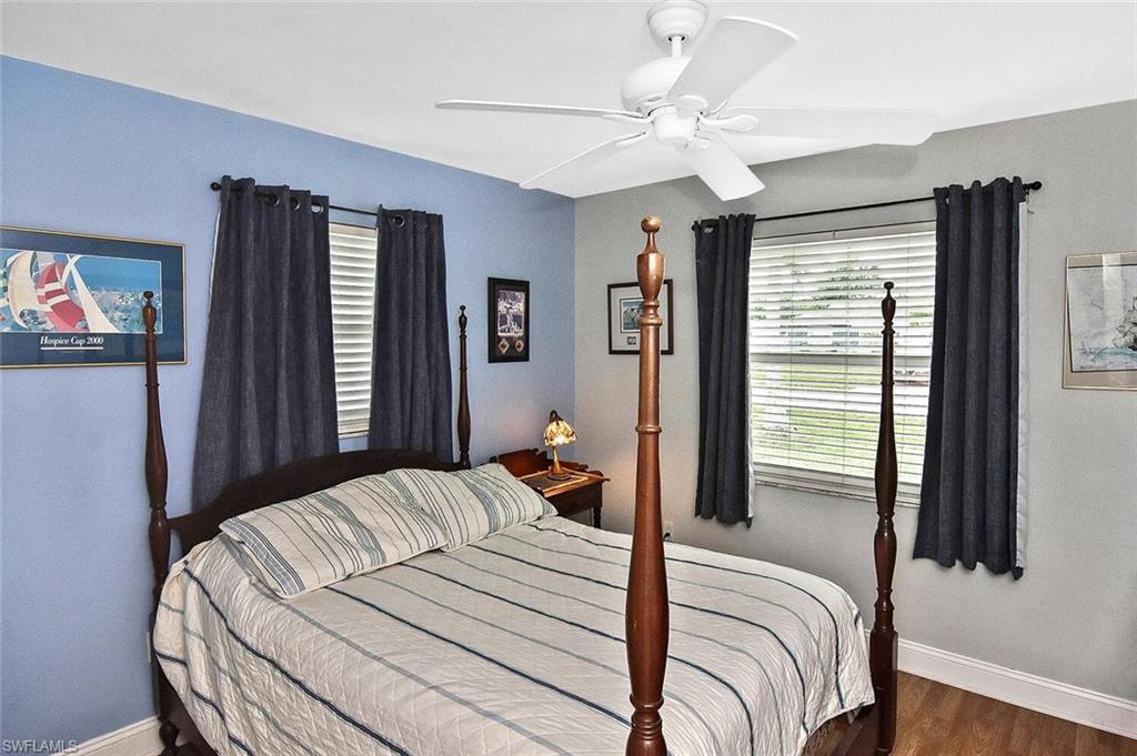 19031 Evergreen Road Fort Myers, FL 33967 - Photo 27 of 44 a bedroom with a large bed and a chandelier