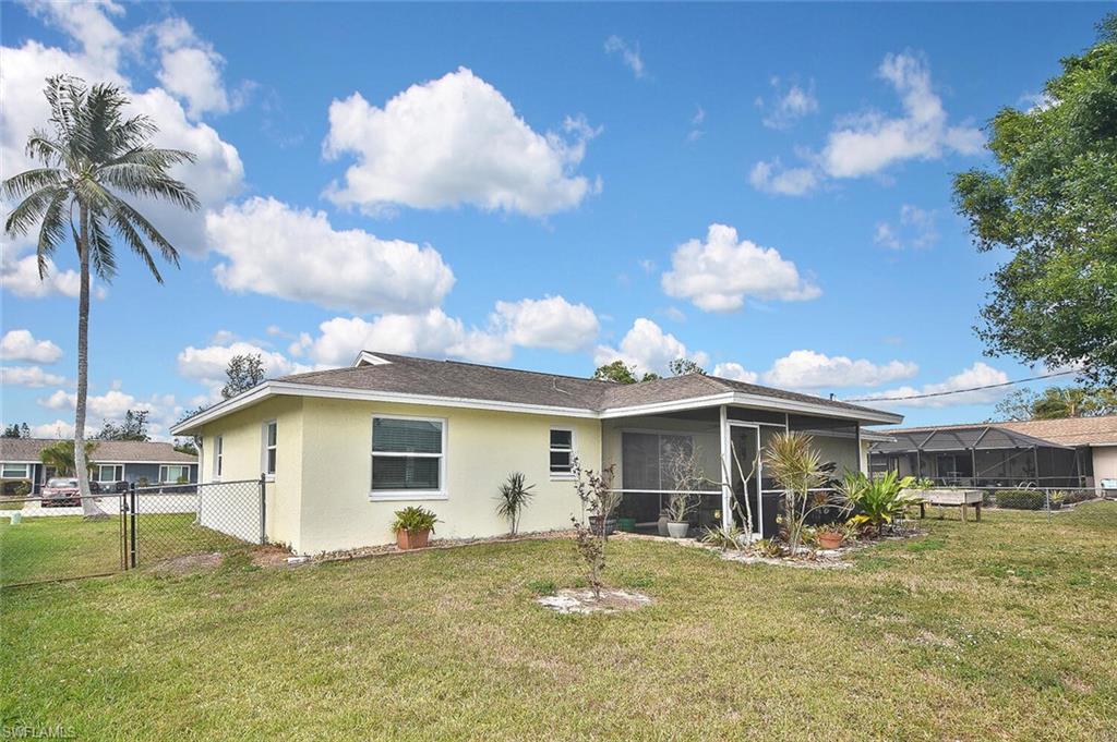 19031 Evergreen Road Fort Myers, FL 33967 - Photo 43 of 44 a view of a white house with a big yard and potted plants