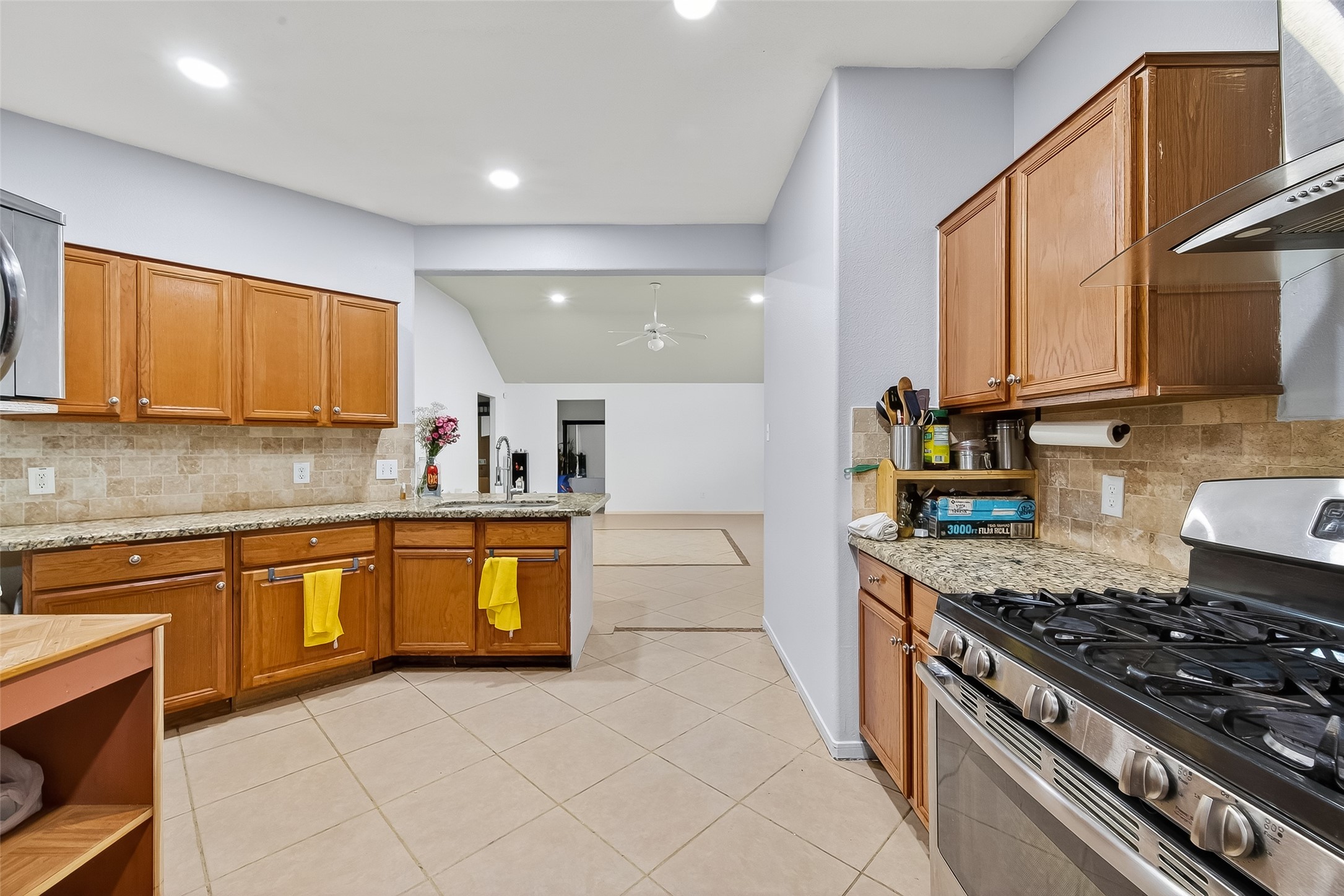 19322 Dawn Canyon Road Houston, TX 77084 - Photo 12 of 33 a kitchen with stainless steel appliances granite countertop a stove a sink and a microwave