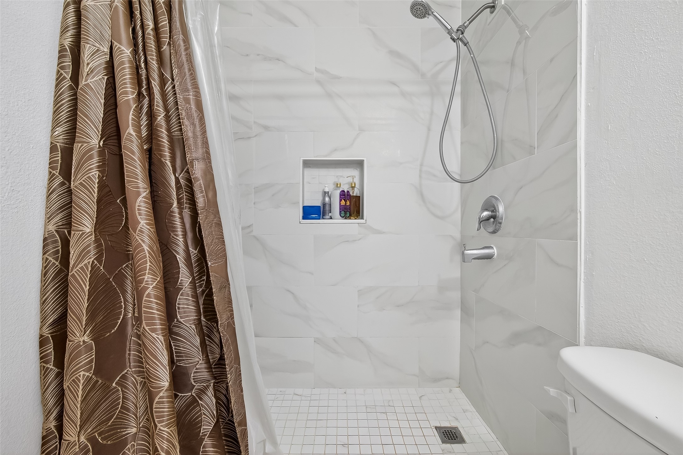 19322 Dawn Canyon Road Houston, TX 77084 - Photo 16 of 33 a bathroom with a shower curtain and a glass door