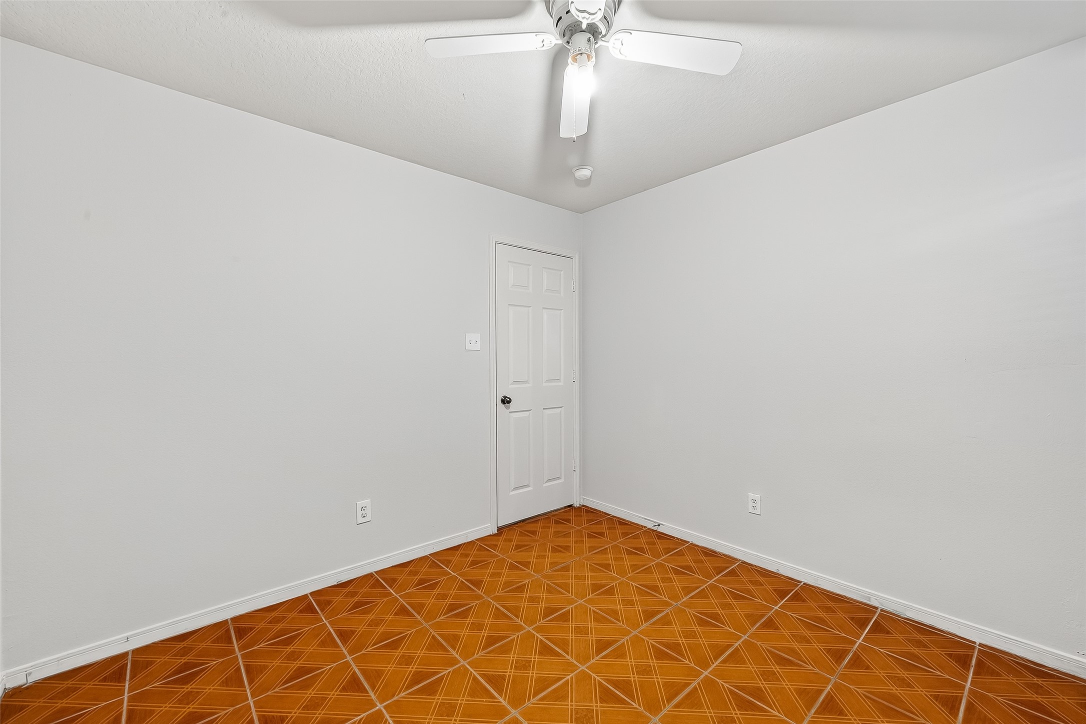 19322 Dawn Canyon Road Houston, TX 77084 - Photo 21 of 33 an empty room with a chandelier fan and wooden floor