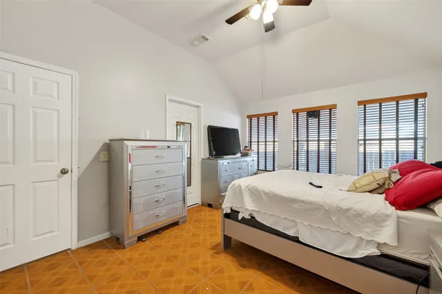 a bedroom with a bed and a flat tv screen