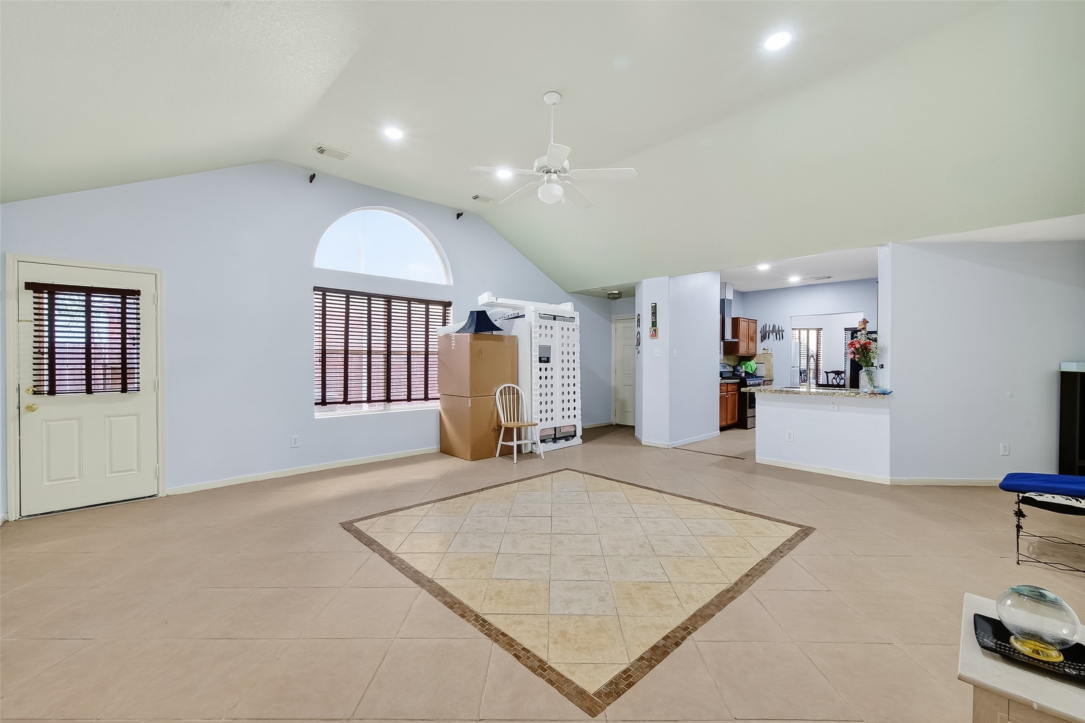 19322 Dawn Canyon Road Houston, TX 77084 - Photo 7 of 33 a view of an empty room and kitchen with wooden floor