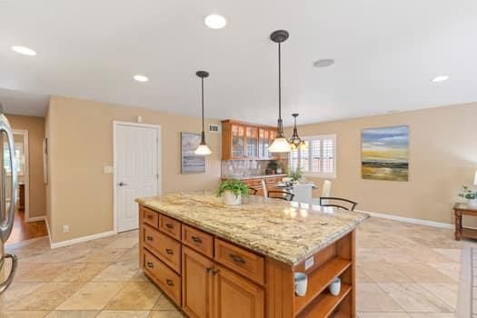 a kitchen island with granite countertop sink and a granite counter top