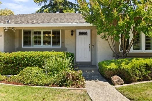 a front view of a house with garden