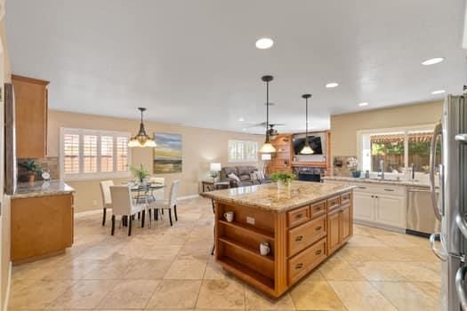 a kitchen with stainless steel appliances granite countertop a stove and a refrigerator