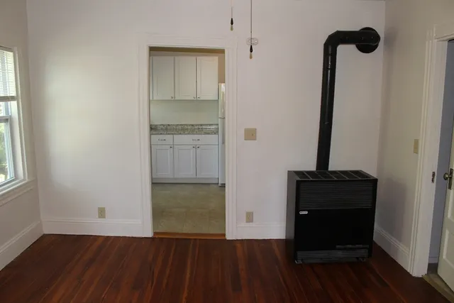 a view of a closet area with wooden floor